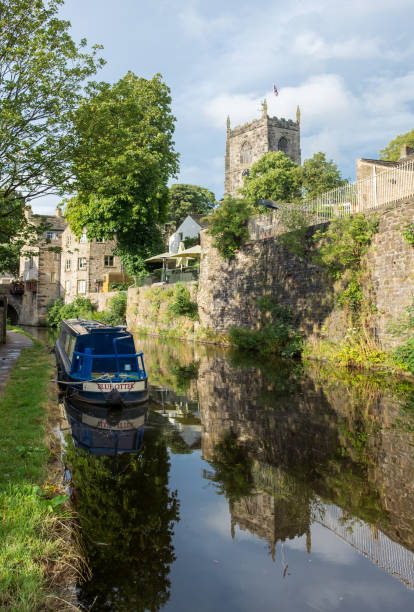 Narrowboats on the Thanet canal in Skipton. Holy Trinity Church in the background stock photo