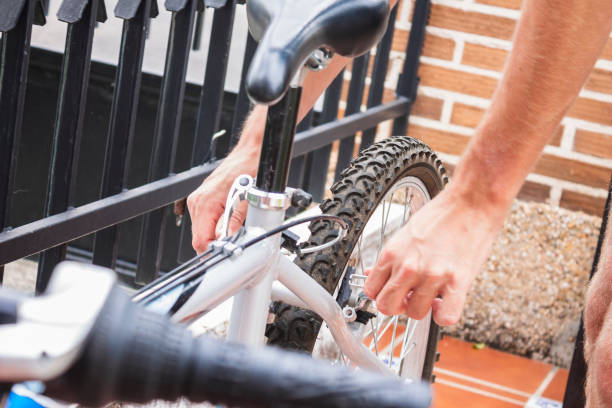 istock Hands fixing the back brakes of a bicycle 1262891493