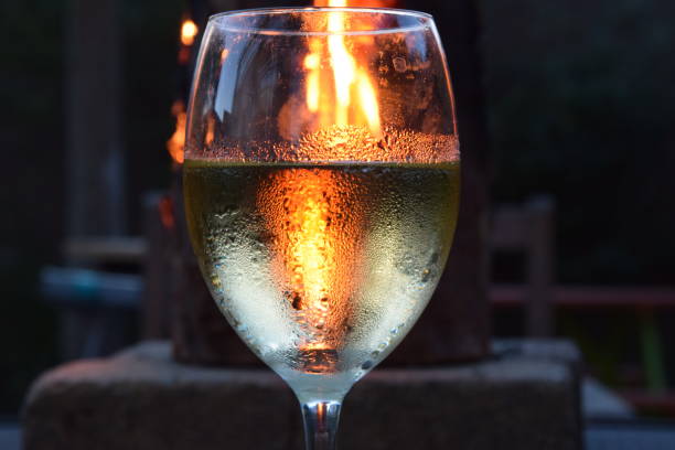 glass of wine on a summer night with fire stock photo