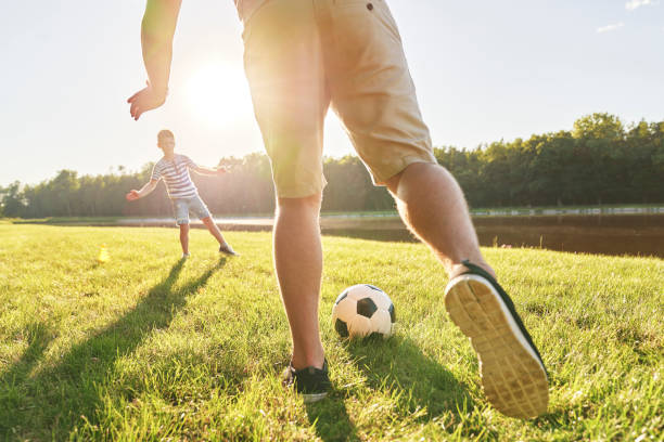 istock Father and son training soccer on holiday 1262893177