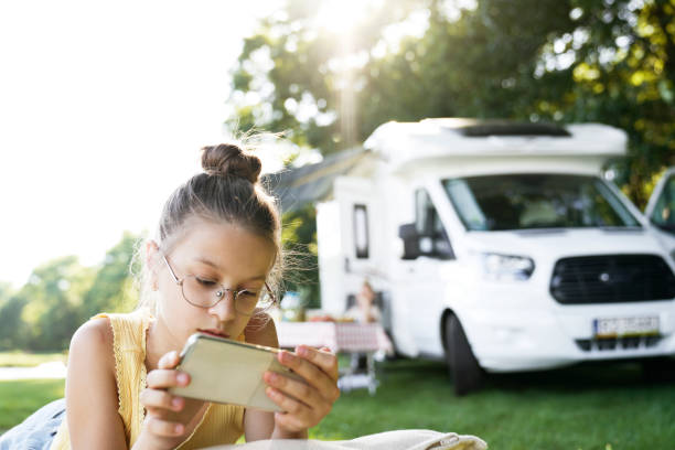 istock Bored child using mobile phone on holiday time 1262894815