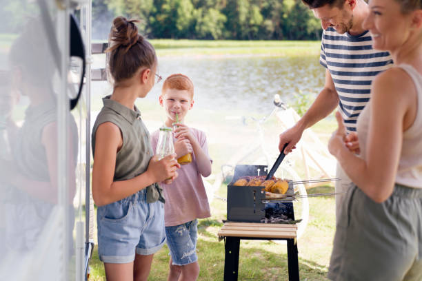 istock Family having barbecue during camper trip 1262894907