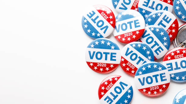istock Pile of patriotic voting buttons on white background 1262894942