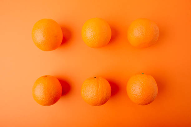 istock round juicy ripe oranges on an orange background 1262896865