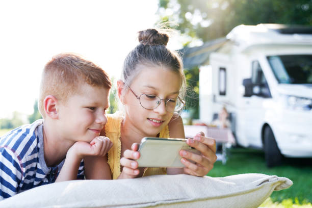 istock Children with mobile phone on camping holiday 1262897081