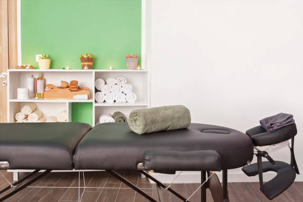 Place for relaxation in modern wellness salon with table bed