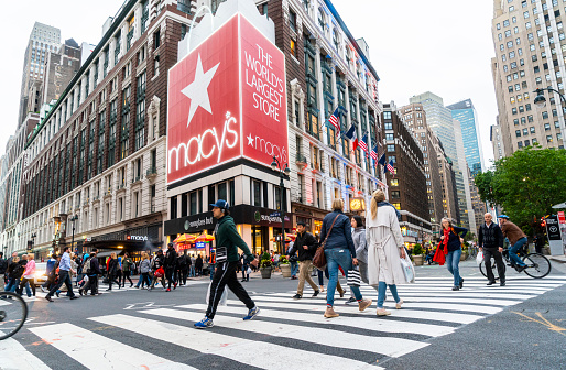 New York City, USA - May 19, 2016: Macy's Herald Square Store which is the flagship store for Macy's located on Herald Square in Manhattan, New York City. Pedestrians in crosswalk at busy midtown Manhattan shopping district of Herald Square. Image taken with a wide angle lens