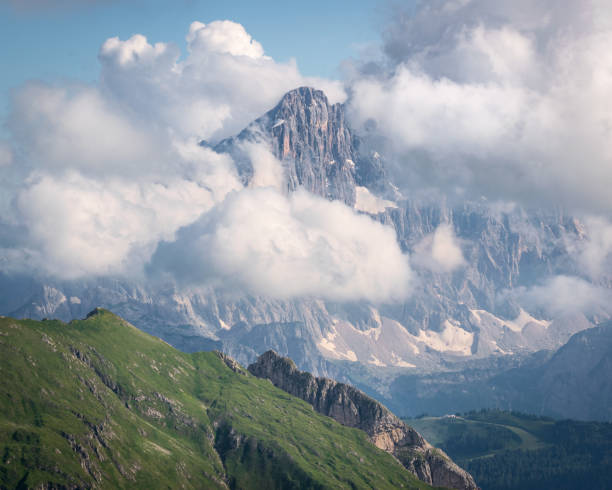 The great Monte Civetta in Italian Dolomites is bathed in white clouds. The very summit is still visible in the center. stock photo