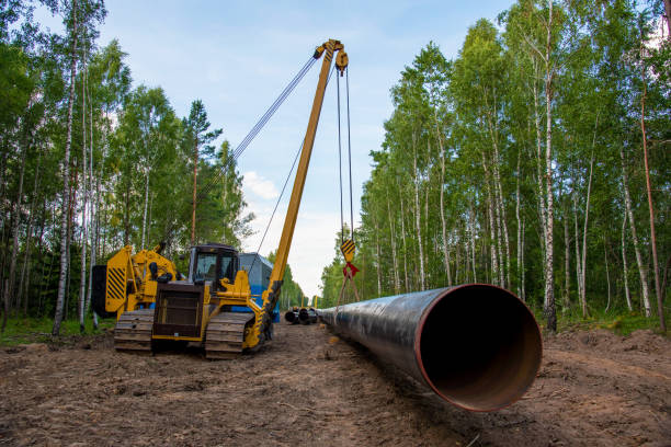 istock Natural gas pipeline construction work in forest area. Crawler crane with side boom Pipelayer Installation of  gas and crude oil pipes in ground 1262910912