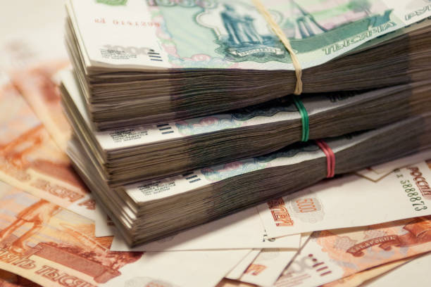 istock A bundle of banknotes on the background of other banknotes 1262911151