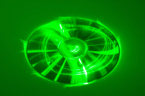 CD under green laser beam Compact disk under green laser beam blu ray disc stock pictures, royalty-free photos & images