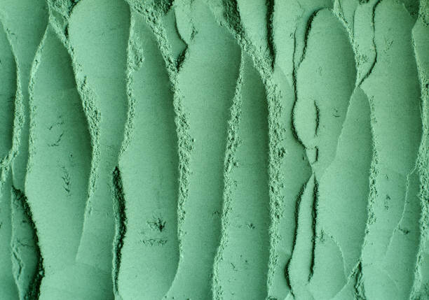 istock Green cosmetic clay powder (kelp facial mask, spirulina body wrap) texture close up, selective focus. Abstract background with brush strokes. 1262912868