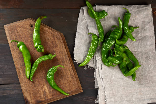 istock green hot pepper pods on a brown wooden table 1262925714