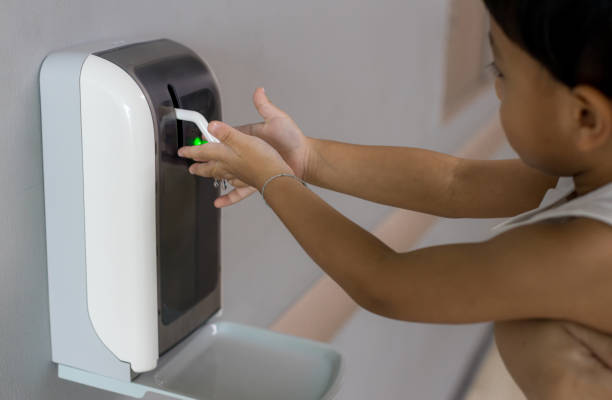 istock Hands under the automatic alcohol dispenser. Infection and hospitably concept. save and protect disease virus against germs and clean in the public area. Clean your hand  protect corona virus. 1262931209