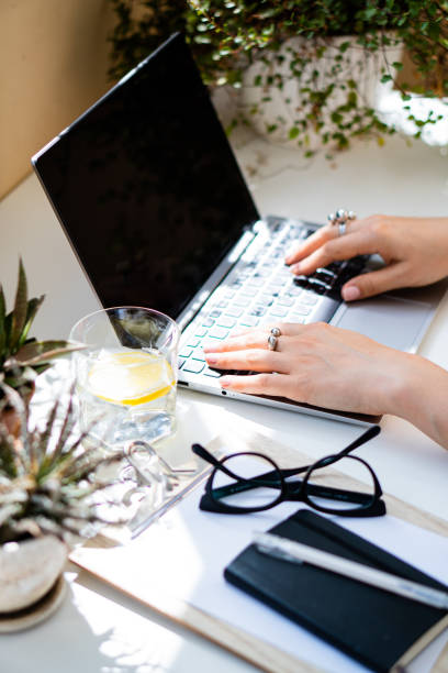 istock Woman's hands on laptop keyboard, cozy workplace 1262932354