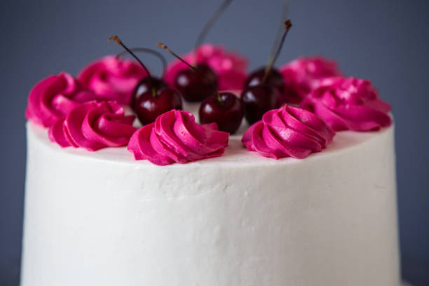 istock White Cream Icing Cake with Fruits, on blue background 1262933499