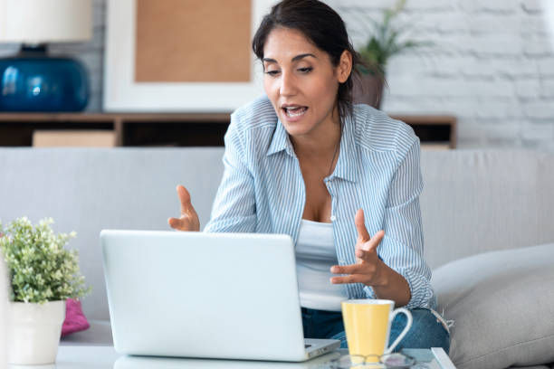 istock Business woman having online video call via laptop computer while working remotely from home. 1262944451