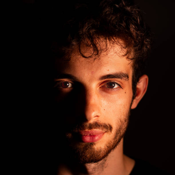 istock portrait man shadows light man teenager 1262949632
