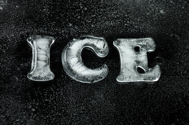 Freezing river bank. closeup of snow, ice, water and rocky bottom
