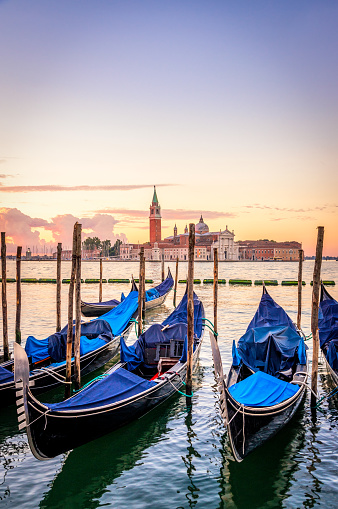 Gondolas with San Giorgio Maggiore at sunrise, Venice, Italy