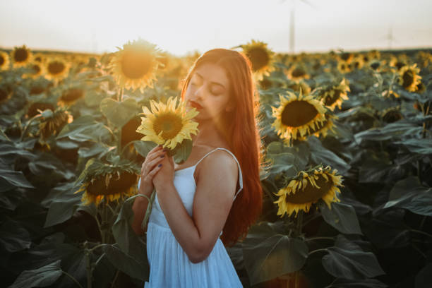 istock Woman in a Sunflower Field 1262957700