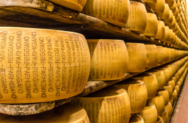 Parmagiano Reggiano cheese aging parmigiano-Reggiano or Parmesan cheese, is a hard, granular cheese made in Italy. table ledge stock pictures, royalty-free photos & images