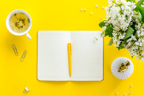 istock Jasmine flowers bouquet with cup tea and notepad top view 1262958796
