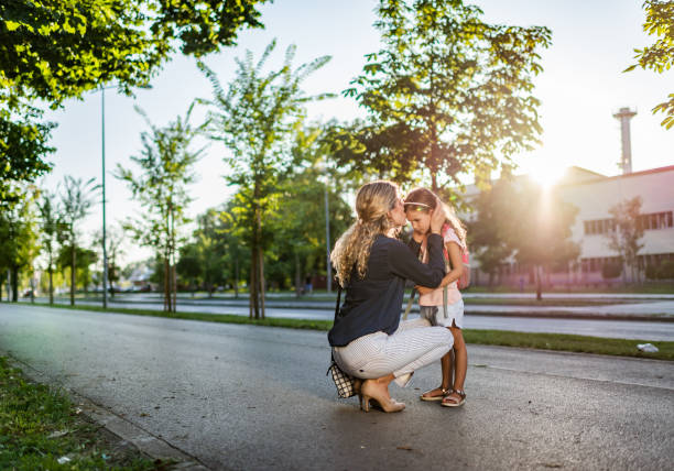 istock Mother kissing her daughter 1262961307