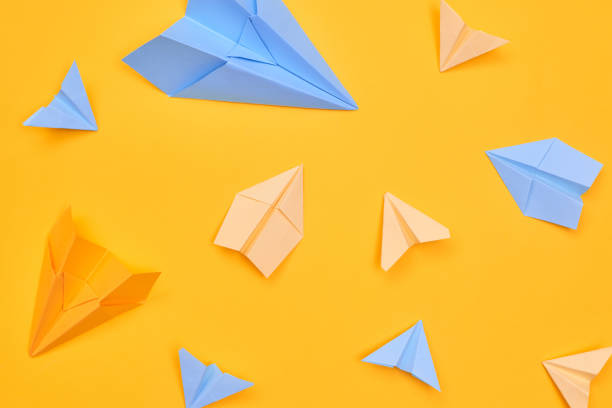istock paper planes on a yellow background. travel flat layer,one 1262961647