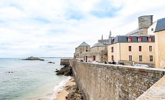 St Malo, France. Saturday 25 July 2020. People on the coast at St Malo in France on an overcast day.