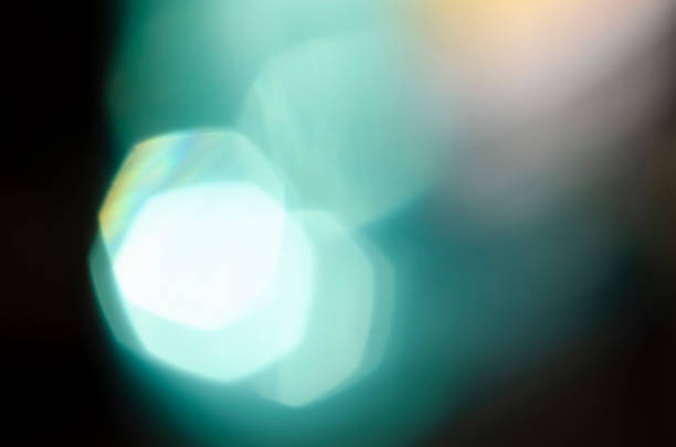 istock Turquoise bokeh on a dark background. Blur, defocusing. Template. Backdrop. Blue shades. Rounds. 1262963341
