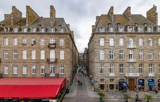 St Malo, France. Saturday 25 July 2020. People visit shops and cafes on the narrow streets of St Malo in France.