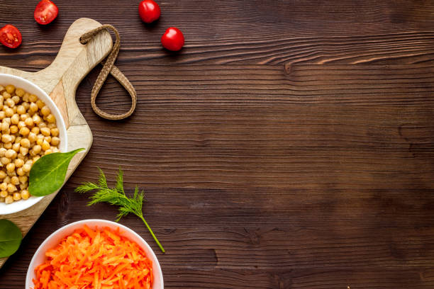 istock Vegetarian bowl with chickpeas and vegetables - wooden table top view copy space 1262964911