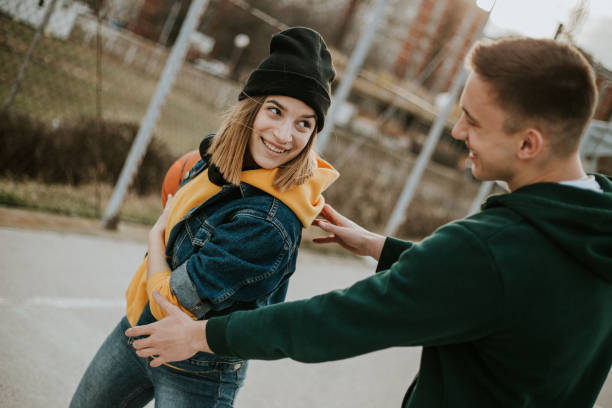 istock Happy couple is playing basketball and having fun 1262965427