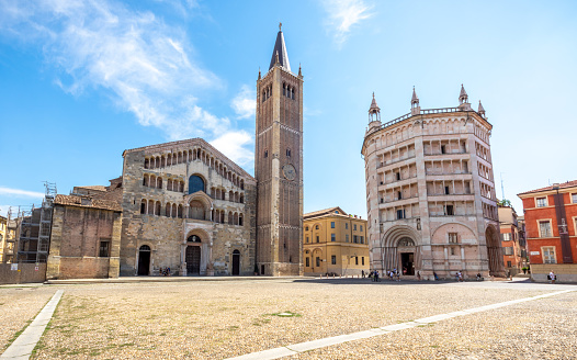 View of Clock Tower (Torre Civica or Torre di Piazza), Trento flag and walls of Palazzo Pretorio in a sunny day; Trento, Trentino-Alto Adige, Italy