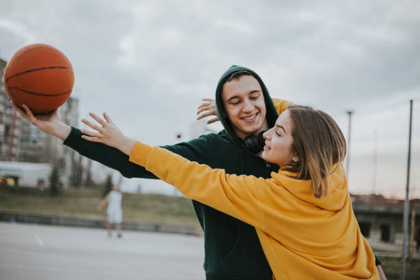 istock Happy couple is playing basketball and having fun 1262967644