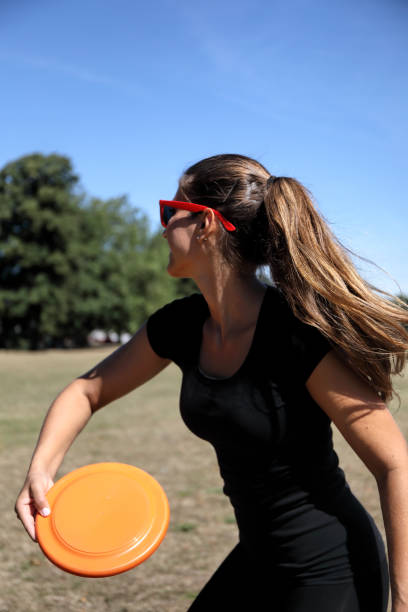 istock Orange plastic disc toy thrown by beautiful Russian model 1262967668