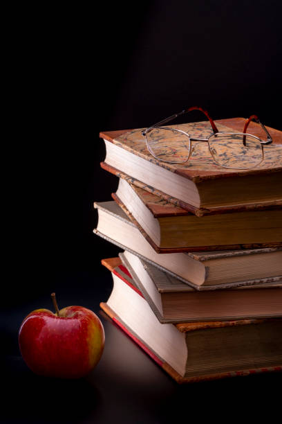 istock Five old books with glasses and an apple 1262967750