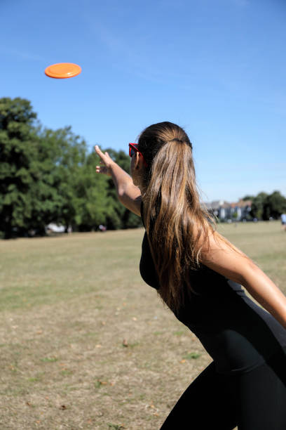 istock Orange plastic disc toy thrown by beautiful Russian model 1262967873