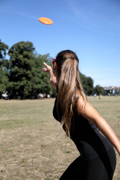 istock Orange plastic disc toy thrown by beautiful Russian model 1262967977