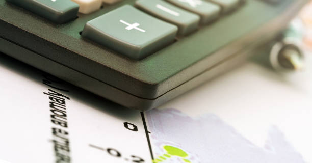 istock black outdated calculator edge with sign plus on papers 1262968152