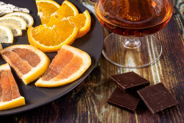 Cognac in a glass and an appetizer. Appetizer for alcohol, dear spirits.