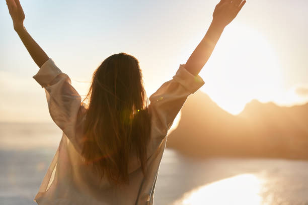 istock Happy woman open arms at mountain peak cliff. 1262971706