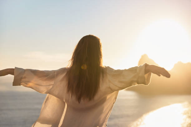 istock Happy woman open arms at mountain peak cliff. 1262971838