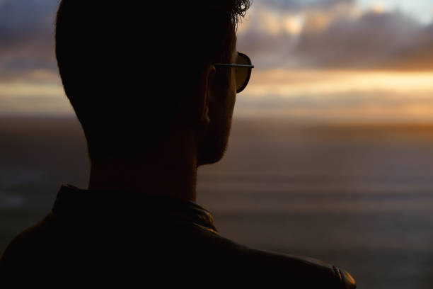 istock Silhouette man looking at sunset with amazing sea view. 1262971939