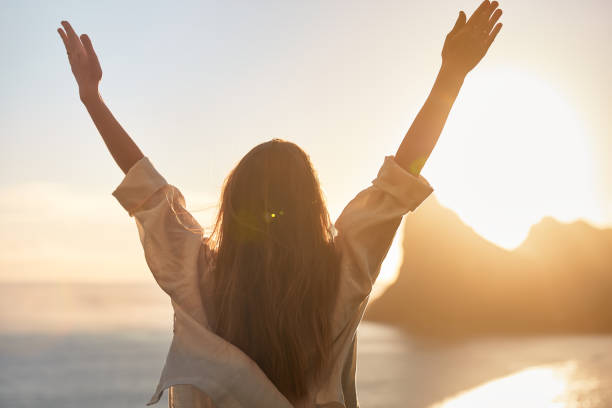 istock Happy woman open arms at mountain peak cliff. 1262971952