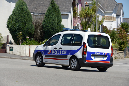 Police vehicle driving in a street in Vannes, Brittany