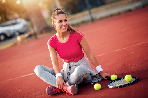 Sport young woman on tennis court.Female tennis player.