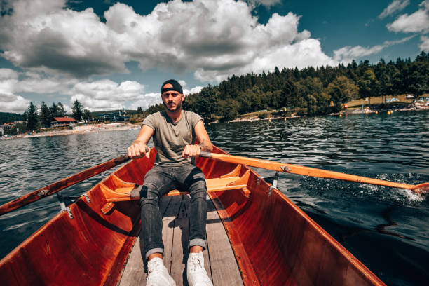 istock Young man rowing on a lake in Germany 1262986362