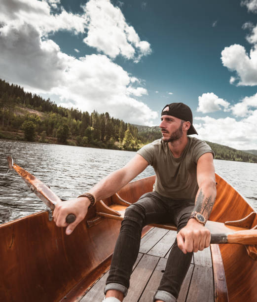 istock Young man rowing on a lake in Germany 1262986382